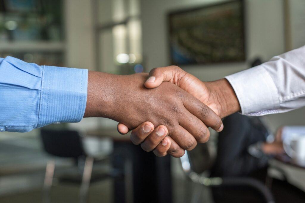 Handshake symbolizing trust after learning how to write an apology email to a customer